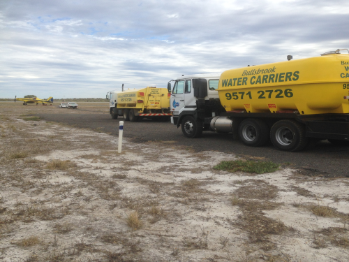 water truck convoy being filled up